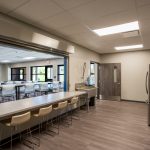 The kitchen and dining area at Metro Technology Centers- Wellness and Community Outreach Center was designed by Renaissance Architecture.
